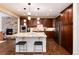 Modern kitchen featuring a stone fireplace, a center island with seating, and stainless steel appliances at 10618 Soulmark Way, Highlands Ranch, CO 80126