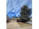 Charming two-story home with a well-maintained lawn, a large tree and a two-car garage at 5221 E Prescott Ave, Castle Rock, CO 80104