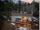Back of house with deck and patio featuring outdoor seating and wooded views at 28254 Tresine Dr, Evergreen, CO 80439