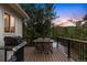 Relaxing back deck featuring a dining table, grill, and an amazing forest view at 28254 Tresine Dr, Evergreen, CO 80439