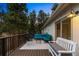 Inviting back deck with stylish outdoor seating, a rug, and a bench at 28254 Tresine Dr, Evergreen, CO 80439