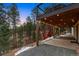Inviting back deck with hanging chairs and string lights, perfect for outdoor relaxation at 28254 Tresine Dr, Evergreen, CO 80439