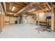 Unfinished basement with laundry area, workbench, and exercise space offers potential for customization and added living space at 28254 Tresine Dr, Evergreen, CO 80439