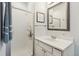 Bright bathroom featuring a white vanity, framed mirror, and a glass-enclosed shower at 28254 Tresine Dr, Evergreen, CO 80439