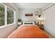 Bedroom featuring a view of the trees, with a comfortable bed and two side tables at 28254 Tresine Dr, Evergreen, CO 80439