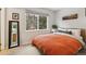 Bedroom featuring a view of the trees, with a comfortable bed and a dresser at 28254 Tresine Dr, Evergreen, CO 80439