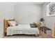 Cozy bedroom with a wood frame bed, neutral walls, and a bright window at 28254 Tresine Dr, Evergreen, CO 80439