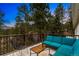 Spacious deck offering comfortable seating and tables perfect for entertaining and enjoying nature at 28254 Tresine Dr, Evergreen, CO 80439