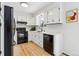 Bright kitchen featuring white cabinets, black appliances, and modern fixtures at 28254 Tresine Dr, Evergreen, CO 80439