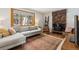 Cozy living room featuring a stone fireplace, comfortable sofa and a view of the trees at 28254 Tresine Dr, Evergreen, CO 80439