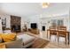 Open living room with stone fireplace and dining area with views of the outdoor landscape at 28254 Tresine Dr, Evergreen, CO 80439