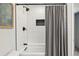 Modern shower featuring subway tiles, black fixtures, and a grey curtain at 28254 Tresine Dr, Evergreen, CO 80439