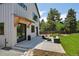 Spacious backyard with a concrete patio, dark frame windows, and modern white siding at 1321 W Caley Ave, Littleton, CO 80120