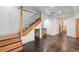 Finished basement featuring a staircase, modern lighting and stained concrete flooring at 1321 W Caley Ave, Littleton, CO 80120