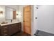 Bathroom with a modern vanity, custom lighting, and a walk-in shower at 1321 W Caley Ave, Littleton, CO 80120