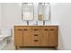 Bathroom featuring a double vanity, stylish mirrors, and modern fixtures at 1321 W Caley Ave, Littleton, CO 80120