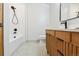 Modern bathroom with a stylish vanity, walk-in shower, and unique flooring at 1321 W Caley Ave, Littleton, CO 80120