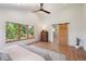 This bedroom features wood floors, backyard views and ensuite bath with glass shower at 1321 W Caley Ave, Littleton, CO 80120