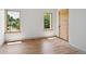 Bright bedroom featuring two windows, hardwood floors, and modern trim at 1321 W Caley Ave, Littleton, CO 80120