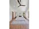 This bedroom features a large rug, ceiling fan, and large windows with backyard views at 1321 W Caley Ave, Littleton, CO 80120