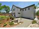 Exterior view showcasing modern architecture with white siding, gravel landscaping, and mature trees at 1321 W Caley Ave, Littleton, CO 80120