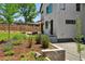 Exterior angle of home showing a modern design, white siding, and nicely landscaped yard with green grass at 1321 W Caley Ave, Littleton, CO 80120