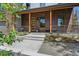 Inviting front porch with stylish wood columns, modern railings, and well-maintained landscaping at 1321 W Caley Ave, Littleton, CO 80120