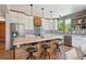 Well-equipped kitchen with stainless steel appliances, island seating, and modern backsplash at 1321 W Caley Ave, Littleton, CO 80120