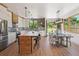 Modern kitchen and dining area with island seating, stainless appliances, and patio access at 1321 W Caley Ave, Littleton, CO 80120