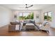 Spacious living room with oversized sectional, large windows, and modern ceiling fan at 1321 W Caley Ave, Littleton, CO 80120