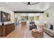 Open-concept living area with hardwood floors, modern furniture, and a spacious kitchen view at 1321 W Caley Ave, Littleton, CO 80120
