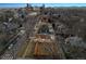 Aerial view of neighborhood with mature trees and city skyline in background, showcasing a charming fenced backyard at 2033 E 21St Ave, Denver, CO 80205