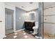 Bathroom featuring modern vanity, toilet, and shower with white tile and stone flooring at 2033 E 21St Ave, Denver, CO 80205
