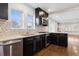 Stylish kitchen featuring granite countertops, stainless steel appliances, and dark wood cabinetry at 2033 E 21St Ave, Denver, CO 80205