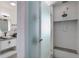 Bathroom featuring a walk-in shower with glass doors, sleek fixtures and a modern vanity with stylish lighting at 14077 Yellow Tip Drive, Parker, CO 80134