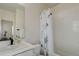 Bright bathroom featuring white cabinets, tile, shower curtain, and modern fixtures at 14077 Yellow Tip Drive, Parker, CO 80134