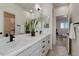 Bathroom featuring a double vanity with modern fixtures, complemented by sleek cabinetry and contemporary design at 14077 Yellow Tip Drive, Parker, CO 80134