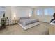 Bedroom featuring modern design with large headboard, bedside tables, and ample natural light from shuttered windows at 14077 Yellow Tip Drive, Parker, CO 80134