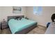 This bedroom has gray walls, gray carpet, plentiful natural light from the windows and a modern bed and side tables at 14077 Yellow Tip Drive, Parker, CO 80134