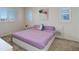 This bedroom boasts a large bed, white walls, gray carpet and plentiful natural light from the windows at 14077 Yellow Tip Drive, Parker, CO 80134