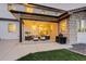 Inviting covered patio with stylish seating, grill area, and string lights, perfect for outdoor entertaining at 14077 Yellow Tip Drive, Parker, CO 80134