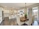 Stylish dining area with modern light fixture and furniture, seamlessly connected to the kitchen at 14077 Yellow Tip Drive, Parker, CO 80134