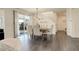 Dining room area with wood floors and light-filled sliding door to outdoor living area at 14077 Yellow Tip Drive, Parker, CO 80134
