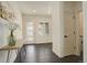 Bright entryway featuring hardwood floors, modern console table, and lots of natural light at 14077 Yellow Tip Drive, Parker, CO 80134