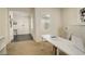 Cozy home office with neutral carpet, a sleek white desk, and ample natural light at 14077 Yellow Tip Drive, Parker, CO 80134