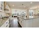 Open-concept kitchen with granite countertops, modern appliances, and views of the living space at 14077 Yellow Tip Drive, Parker, CO 80134