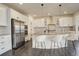 Modern kitchen with stainless steel appliances, center island with seating, and ample counter space at 14077 Yellow Tip Drive, Parker, CO 80134
