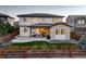 Home's rear exterior featuring a covered patio, landscaped backyard, and privacy fence at 14077 Yellow Tip Drive, Parker, CO 80134