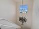 Stairway landing with modern light fixture and window with neighborhood views at 14077 Yellow Tip Drive, Parker, CO 80134