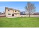 Spacious backyard with a well-maintained lawn, patio and fire pit, perfect for outdoor entertaining and relaxation at 5210 Roadrunner Ave, Firestone, CO 80504